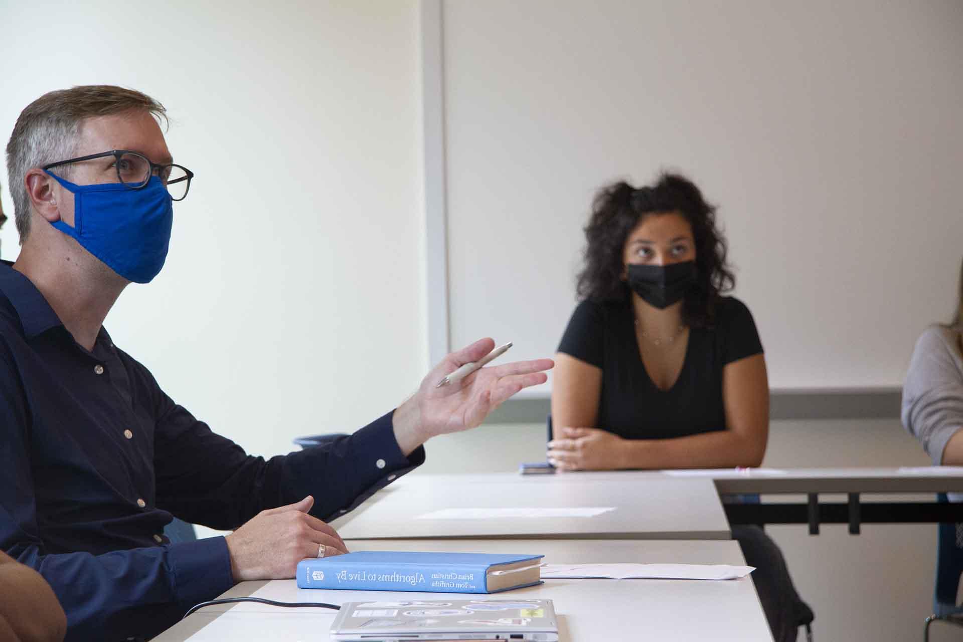 Students hold a discussion in a classroom.