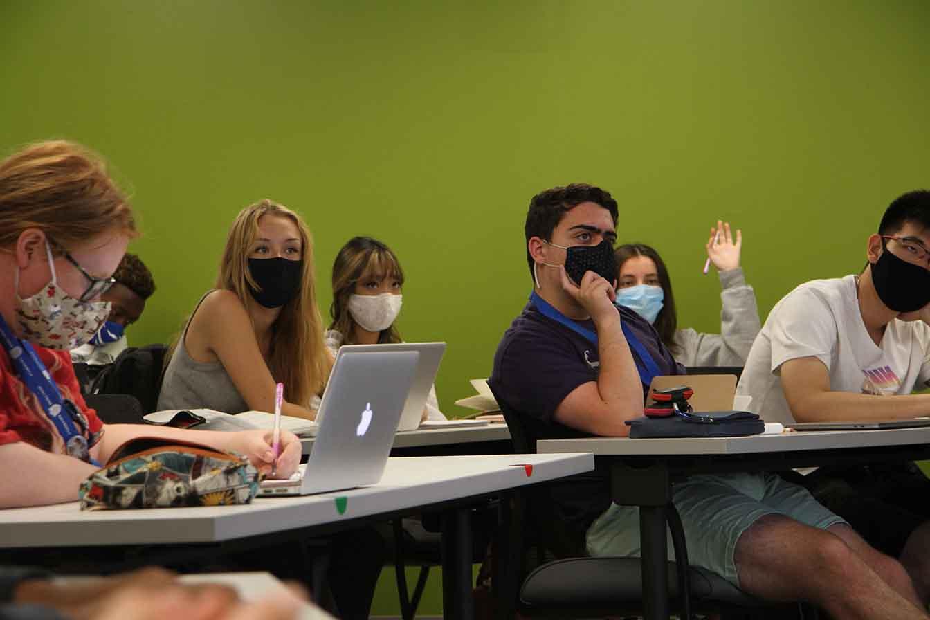 Students take in a lecture in a classroom.